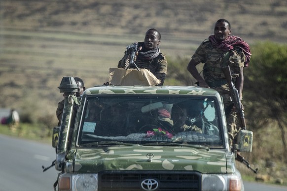 FILE - In this Saturday, May 8, 2021 file photo, Ethiopian government soldiers ride in the back of a truck on a road near Agula, north of Mekele, in the Tigray region of northern Ethiopia. Ethiopia&#0 ...