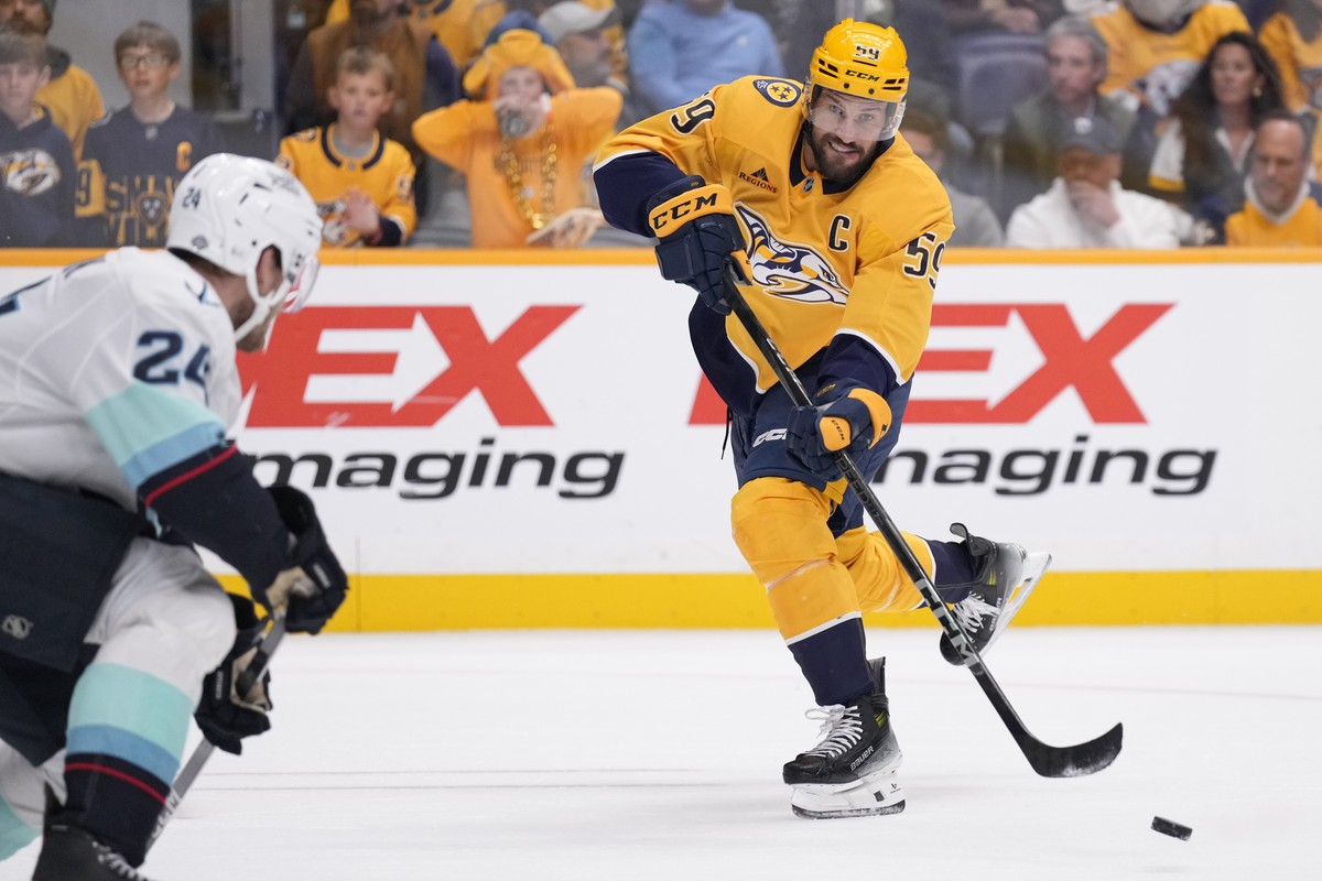 Nashville Predators defenseman Roman Josi (59) passes the puck past Seattle Kraken defenseman Jamie Oleksiak (24) during the second period of an NHL hockey game Tuesday, Oct. 15, 2024, in Nashville, T ...