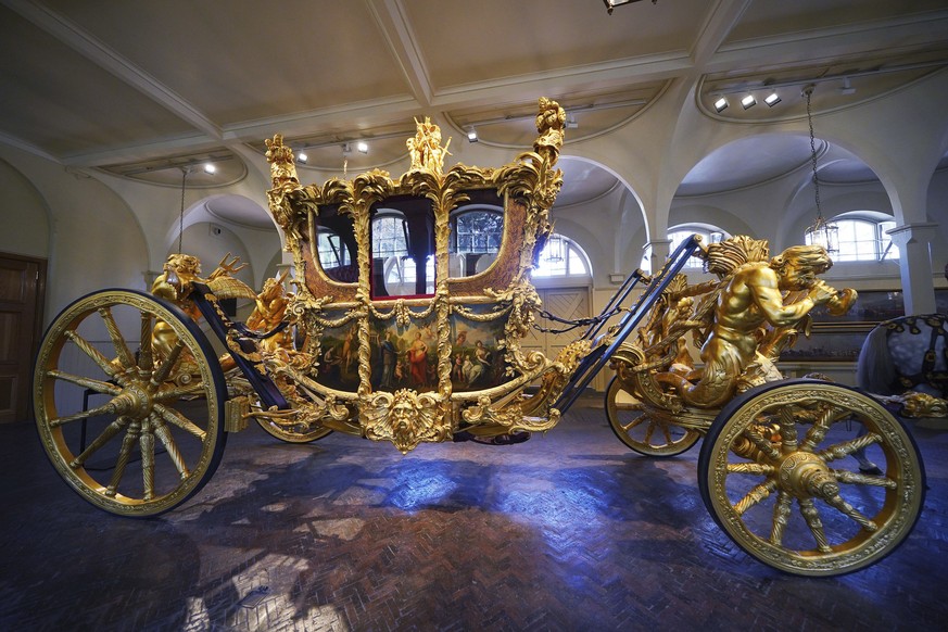The Gold State Coach on display at the Royal Mews in Buckingham Palace, London, Tuesday April 4, 2023, in which King Charles III and the Queen Consort will return in to Buckingham Palace after the cor ...