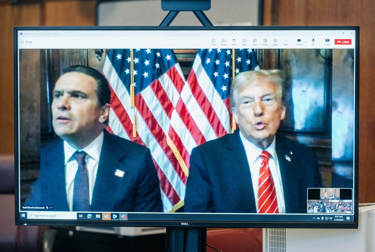 epa11816909 Former US President and president-elect Donald Trump (R) and his attorney Todd Blanche appear on a screen remotely for a sentencing hearing in Trump's hush money criminal case in fron ...