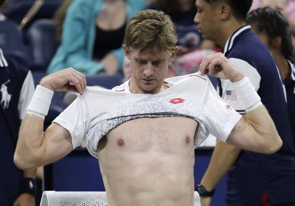 Kevin Anderson, of South Africa, changes his shirt during the third round of the U.S. Open tennis tournament against Denis Shapovalov, of Canada, Friday, Aug. 31, 2018, in New York. (AP Photo/Julio Co ...