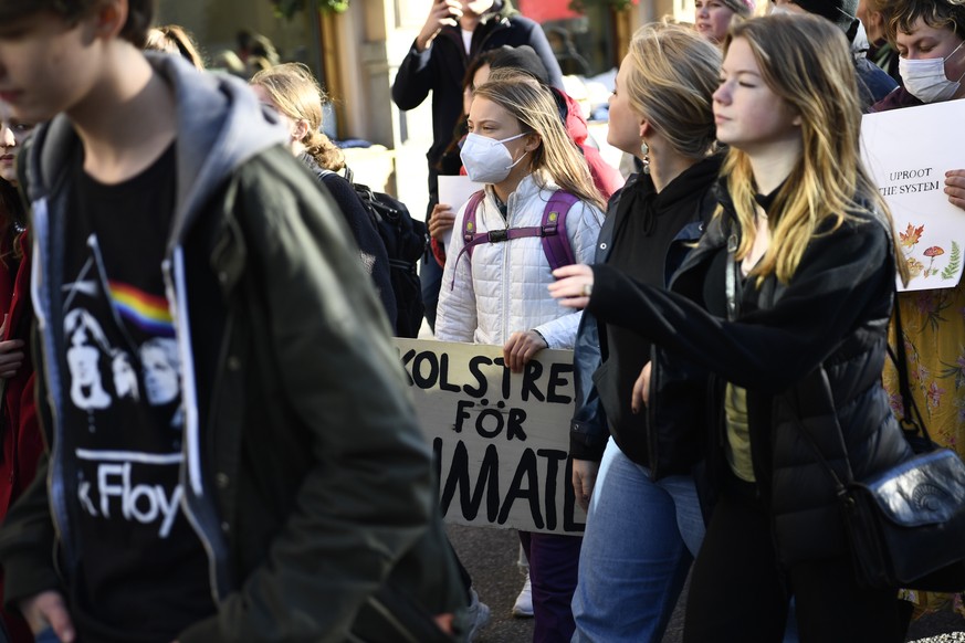 epa09538771 Greta Thunberg (C) attends a Global Climate Strike demonstration organized by Fridays For Future, in Stockholm, Sweden, 22 October 2021. Global Climate Strike demonstrations are held to de ...