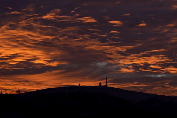 Northern Germany&#039;s 1,142-meter, 3,743 feet, highest mountain &#039;Brocken&#039; at the Harz mountains is silhouetted as the sun sets near Wernigerode, Germany, Monday, Jan. 13, 2025. (AP Photo/M ...