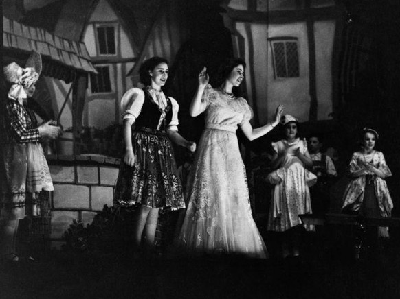 Princess Elizabeth (later Queen Elizabeth II, centre) and Princess Margaret Rose (1930 - 2002, centre, left) performing in a royal production of the Christmas pantomime &#039;Old Mother Red Riding Boo ...