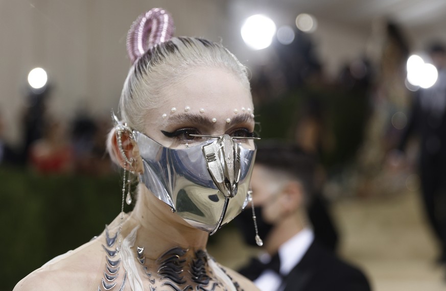 epa09466660 Grimes poses on the red carpet for the 2021 Met Gala, the annual benefit for the Metropolitan Museum of Art's Costume Institute, in New York, New York, USA, 13 September 2021. The eve ...