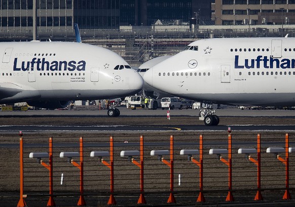 An Airbus A380, left, and a Boeing 747, both from Lufthansa airline pass each other at the airport in Frankfurt, Germany, Thursday, Feb. 14, 2019. The European plane manufacturer Airbus said Thursday  ...