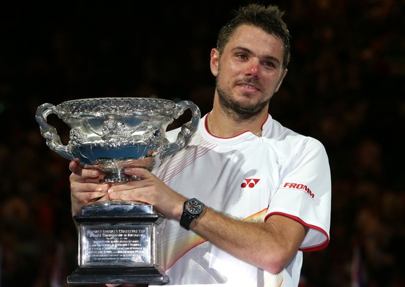 Stanislas Wawrinka of Switzerland holds the trophy after defeating Rafael Nadal of Spain during the men's singles final at the Australian Open tennis championship in Melbourne, Australia, Sunday, ...