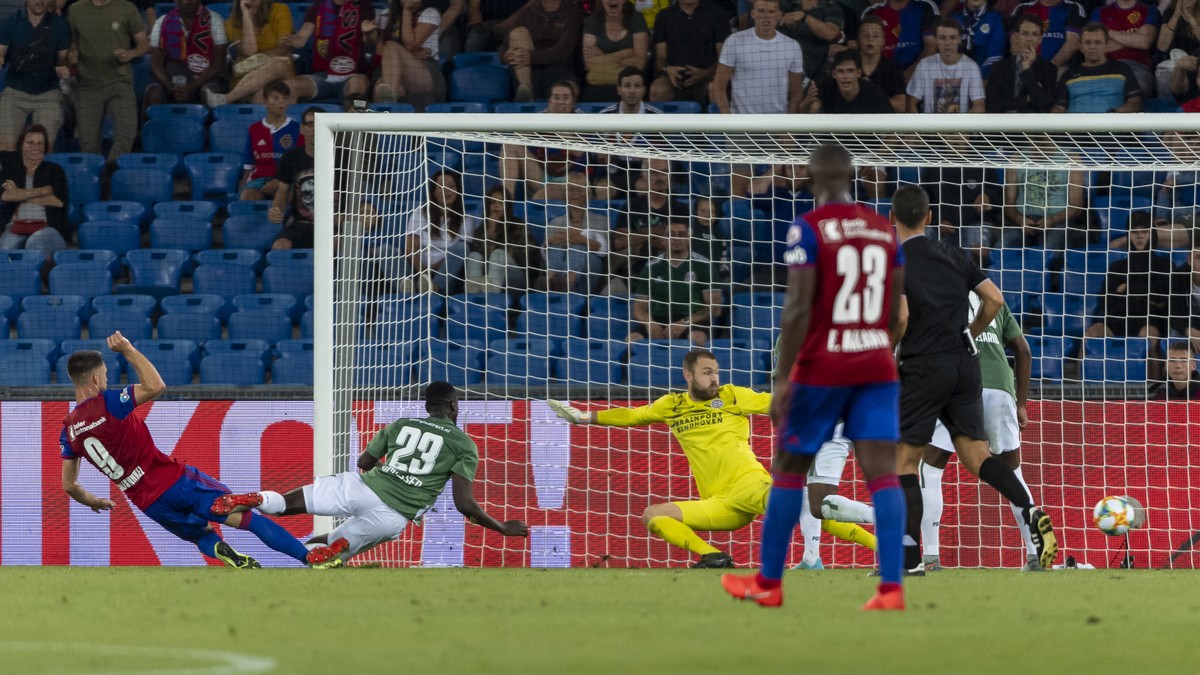 Basel's Ricky van Wolfswinkel, left, scores during the UEFA Champions League second qualifying round second leg match between Switzerland's FC Basel 1893 and Netherland's PSV Eindhoven  ...