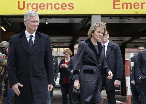 epa05226895 King Philippe (L) and Queen Mathilde of Belgium leave after visiting victims of the terrorist attacks, at Erasmus Hospital in Brussels, Belgium, 23 March 2016. Security services are on hig ...