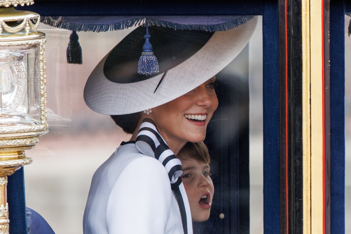 epa11411693 Britain's Catherine Princess of Wales (front) smiles as she travels with Prince Louis (back) from Buckingham Palace to Horse Guards Parade inside a carriage during the Trooping the Co ...