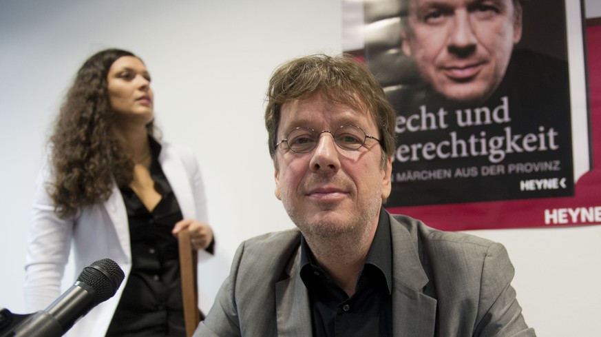 Meteorologist Joerg Kachelmann and his wife Miriam, left, present their book &quot;Recht und Gerechtigkeit - Ein Maerchen aus der Provinz&quot; at the Frankfurt, Germany, book fair, Friday, Oct.12, 20 ...