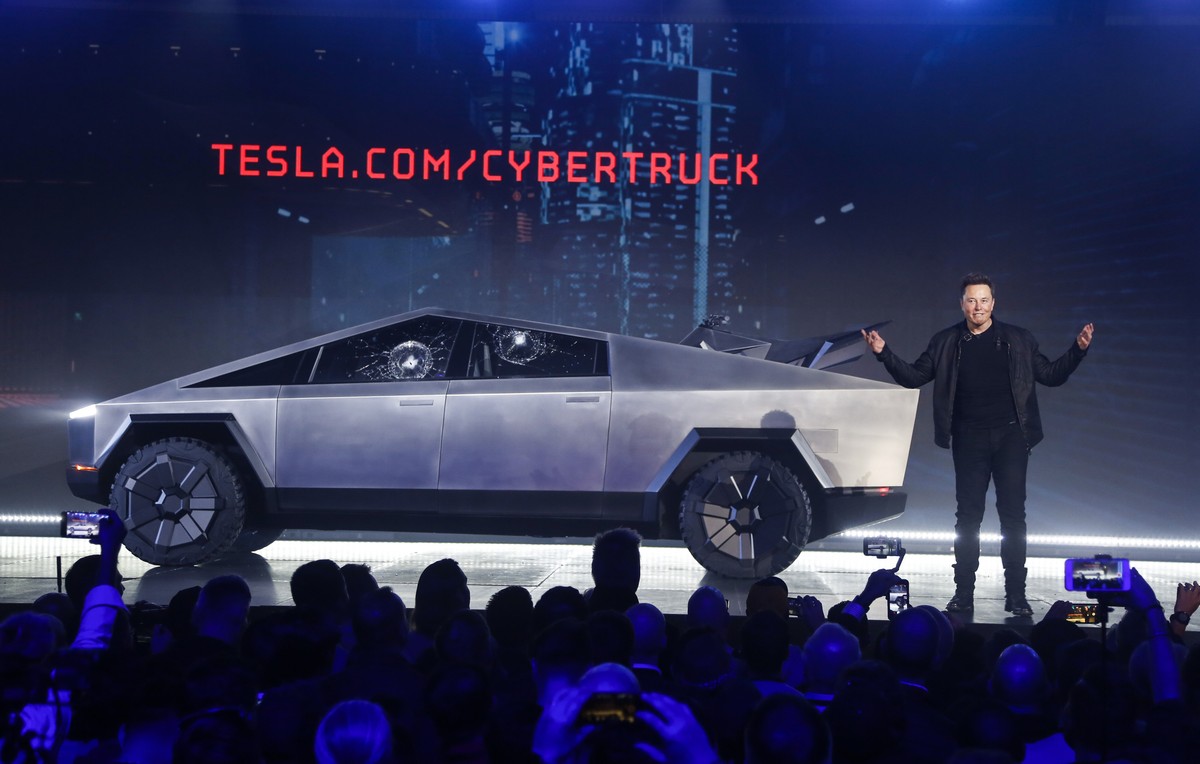 FILE - In this Nov. 21, 2019 file photo, Tesla CEO Elon Musk introduces the Cybertruck at Tesla's design studio in Hawthorne, Calif. The much-hyped unveil of TeslaÄôs electric pickup truck went  ...
