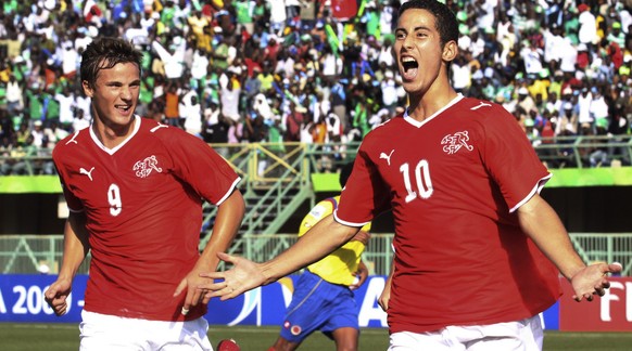 Switzerland&#039;s Nassim Ben Khalifa, right, reacts with fellow team member Haris Seferovic, left, after scoring on a penalty kick against Colombia during their Under-17 World Cup semifinal soccer ma ...