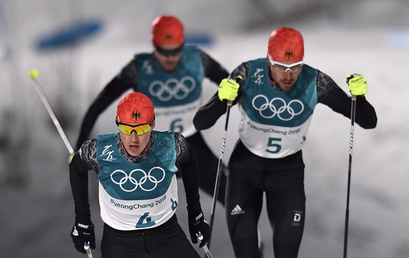 epa06546038 (L-R) Erik Frenzel, Fabian Riessle and Johannes Rydzek of Germany in action during the Cross Country portion of the Nordic Combined Individual Large Hill / 10 km competition at the Alpensi ...