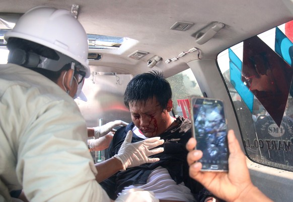 epaselect epa08997969 A demonstrator is tended by medics in an ambulance after police fired water cannon on demonstrators during a protest against the military coup, in Naypyitaw, Myanmar, 09 February ...
