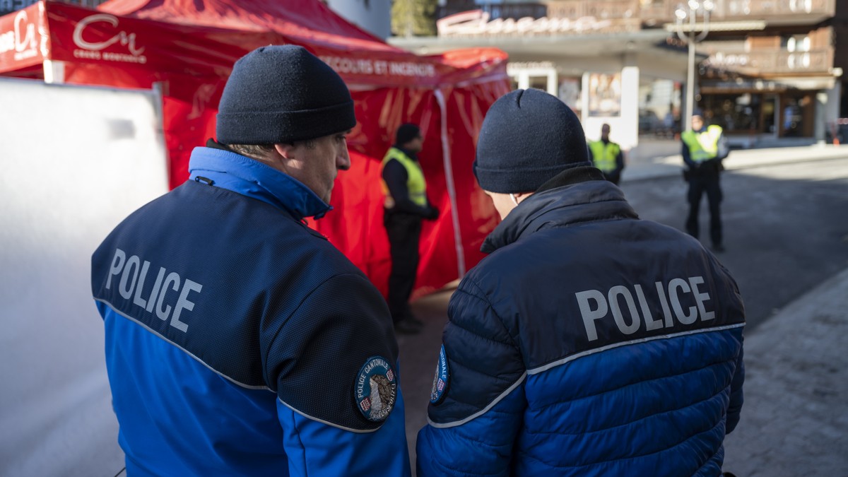 epa12623434 Police officers stand near the site of the deadly fire at the 'Le Constellation' bar, in Crans-Montana, Switzerland, 03 January 2026. At least 40 people lost their lives and over ...