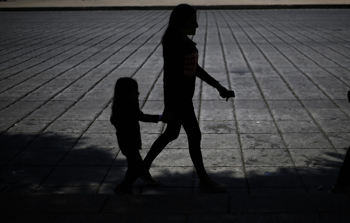 In this Saturday, Oct. 14, 2017 photo, a woman and girl walk during a march against human trafficking and slavery in Mexico City. Dozens of people participated in Mexico City's silent "Walk  ...