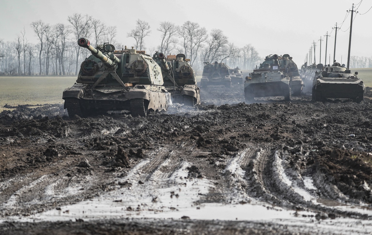 epa09776767 Russian armoured vehicles stand on the road in Rostov region, Russia, 22 February 2022. Russian President Vladimir Putin on 21 February convened an extraordinary large meeting of the Russi ...