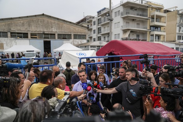 SYRIZA-Progressive Alliance leader Alexis Tsipras speaks to the press after his visit to a warehouse where survivors of a shipwreck take shelter, at the port of Kalamata, about 240 kilometers (150 mil ...
