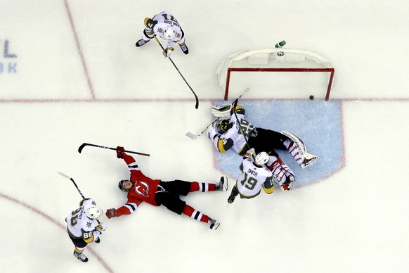 New Jersey Devils center Nico Hischier, second from left, of Switzerland, celebrates after scoring the winning goal against Vegas Golden Knights goaltender Marc-Andre Fleury (29) during overtime of an ...