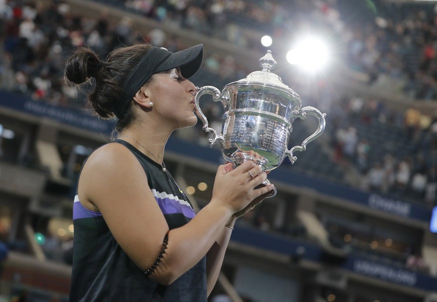 epaselect epa07826857 Bianca Andreescu of Canada celebrates with the championship trophy after defeating Serena Williams of the US during the women's final match on the thirteenth day of the US Open T ...