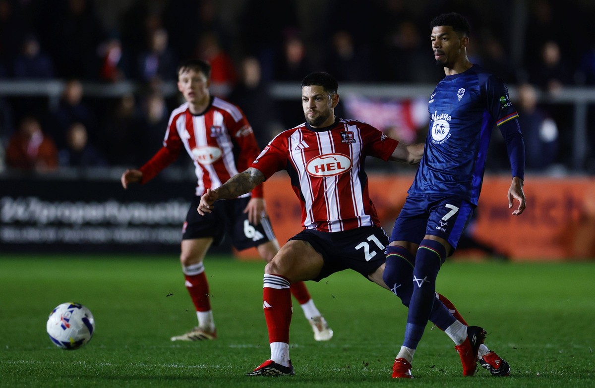 Exeter City v Lincoln City, Exeter, UK - 10 Mar 2026 Danny Andrew of Exeter City battles for the ball with Reeco Hackett-Fairchild of Lincoln City during the EFL League One match between Exeter City a ...