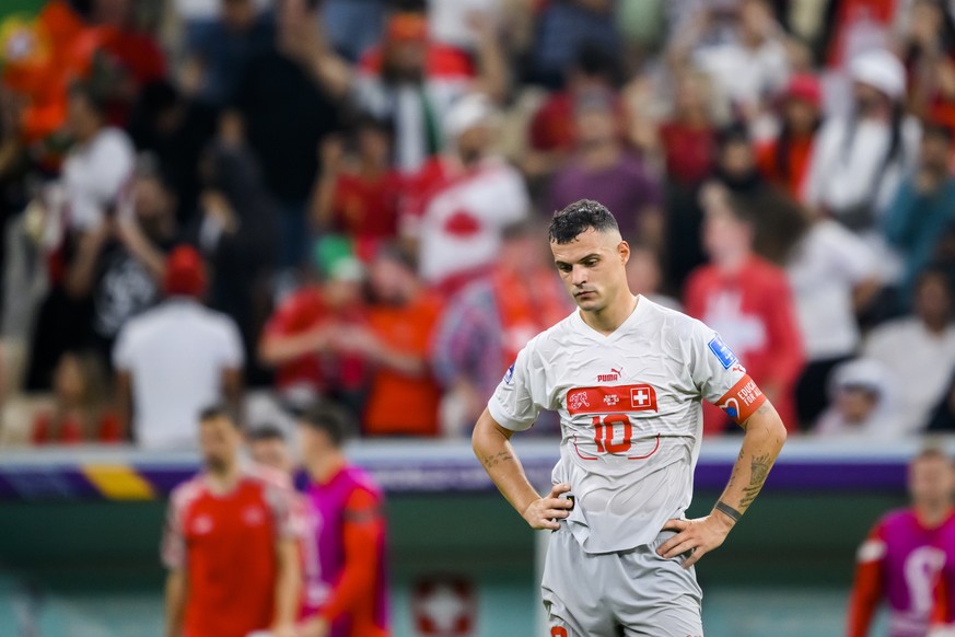 Switzerland&#039;s midfielder Granit Xhaka reacts after the elimination during the FIFA World Cup Qatar 2022 round of 16 soccer match between Portugal and Switzerland at the Lusail Stadium in Lusail,  ...