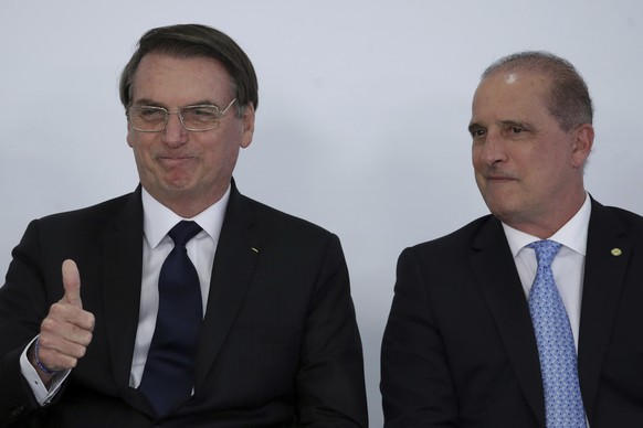 Brazil&#039;s President Jair Bolsonaro, left, gives a thumbs up sign as he stands next to his Chief of Staff Onyx Lorenzoni, during ceremony at the Planalto Presidential Palace in Brasilia, Brazil, Mo ...