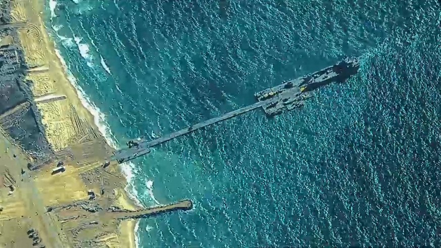 This handout picture courtesy of the US Central Command (CENTOCOM) taken on May 16, 2024 shows US Army Soldiers assigned to the 7th Transportation Brigade (Expeditionary), US Navy Sailors assigned to  ...