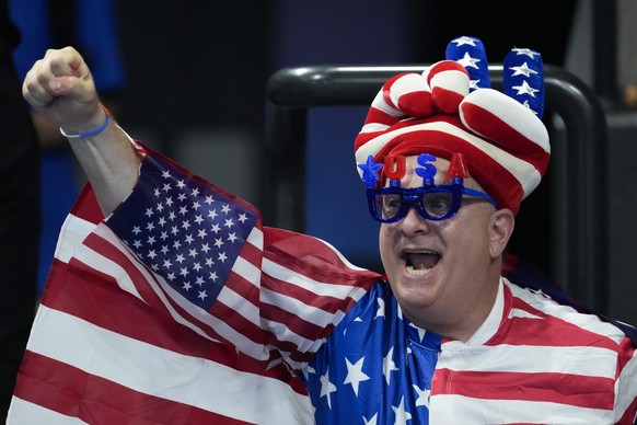 A spectator reacts during the women&#039;s 400-meter individual medley final at the 2024 Summer Olympics, Monday, July 29, 2024, in Nanterre, France. (AP Photo/Matthias Schrader)