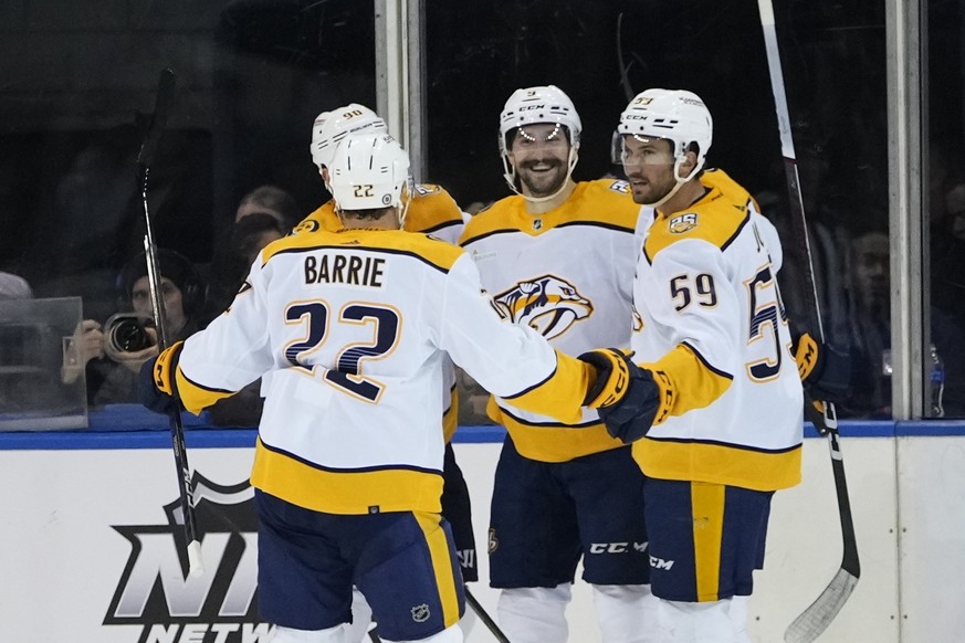 Nashville Predators&#039; Filip Forsberg (9) celebrates with teammates Tyson Barrie (22) and Roman Josi (59) after scoring a goal during the second period of an NHL hockey game against the New York Ra ...