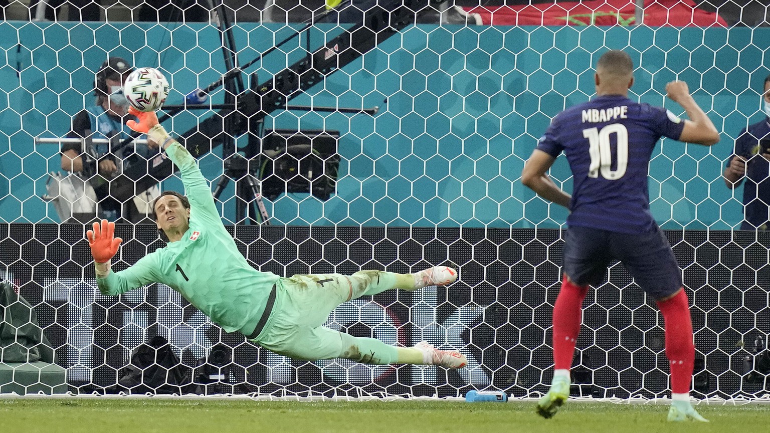 Switzerland&#039;s goalkeeper Yann Sommer saves the penalty shot by France&#039;s Kylian Mbappe during the Euro 2020 soccer championship round of 16 match between France and Switzerland at the Nationa ...