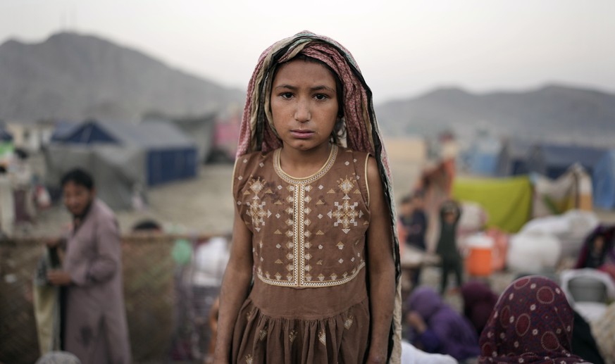 An Afghan refugee girl stands for a portrait in a camp near the Pakistan-Afghanistan border, in Torkham, Afghanistan, Saturday, Nov. 4, 2023. Many Afghan refugees arrived at the Torkham border to retu ...