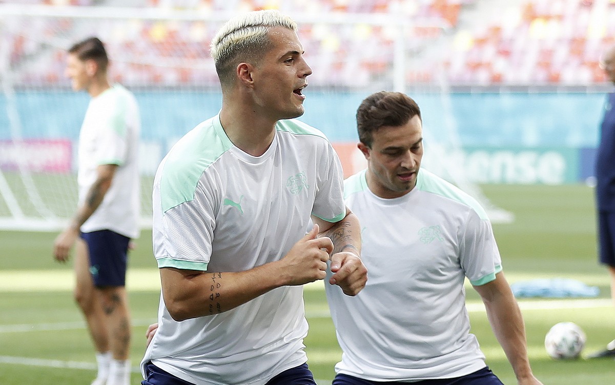 epa09305824 Switzerland's Granit Xhaka (L) and Xherdan Shaqiri (R) attend an official training session at National Arena stadium, in Bucharest, Romania, 27 June 2021. Switzerland will face France ...
