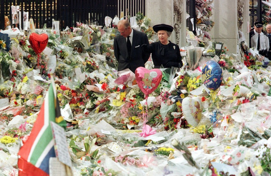 FILE - Britain's Queen Elizabeth II and Prince Philip view the floral tributes to Diana, Princess of Wales, at London's Buckingham Palace, Friday, Sept. 5, 1997. Above all, there was shock.  ...