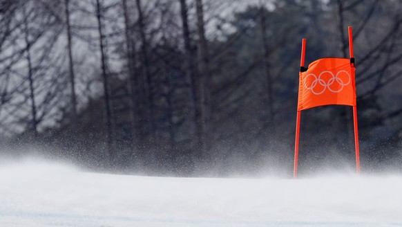 Wind blows snow across the course during men&#039;s downhill training at the 2018 Winter Olympics in Jeongseon, South Korea, Friday, Feb. 9, 2018. The training was delayed by 30 minutes due to high wi ...