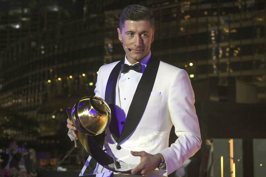 Robert Lewandowski holds the trophy for best player of the year, at the Dubai Globe Soccer Awards ceremony in Dubai, United Arab Emirates, Sunday, Dec. 27, 2020. (Fabio Ferrari/LaPresse via AP)