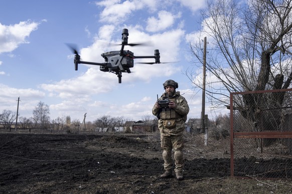 A Ukrainian serviceman aka Zakhar flies a drone during fighting at the frontline near Bakhmut, Ukraine, Friday, March 3, 2023. (AP Photo/Evgeniy Maloletka)