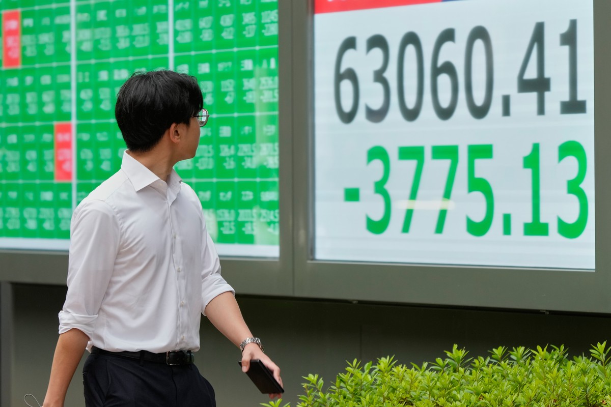 A person walks in front of an electronic stock board showing Japan's Nikkei index at a securities firm Friday, July 17, 2026, in Tokyo. (AP Photo/Eugene Hoshiko)
Japan Financial Markets