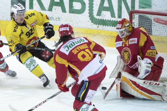 Tiger&#039;s Philippe Seydoux, Mitte, und Goalie Ivars Punnenovs, rechts, kaempfen um den Puck, gegen Bern&#039;s Gaetan Haas, links, waehrend dem Meisterschaftsspiel der National League, zwischen den ...