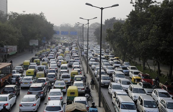 FILE- In this Jan. 16, 2016, file photo, vehicles move slowly through a traffic intersection after the end of a two-week experiment to reduce the number of cars to fight pollution in in New Delhi, Ind ...