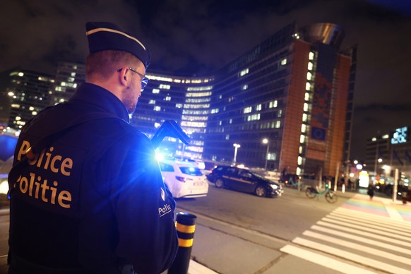 epa10440392 An armed police officer stand guard near Schuman station after a knife attack, in Brussels, Belgium, 30 January 2023. At least one person was injured in a knife attack at Brussels&#039; Sc ...