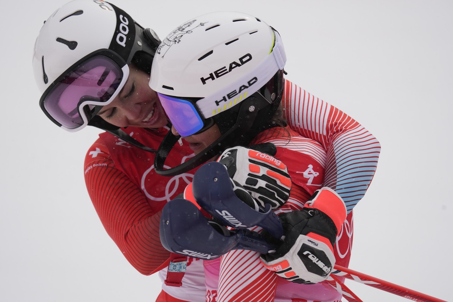 Michelle Gisin, of Switzerland, embraces teammate Wendy Holdener, after finishing the women&#039;s combined slalom at the 2022 Winter Olympics, Thursday, Feb. 17, 2022, in the Yanqing district of Beij ...