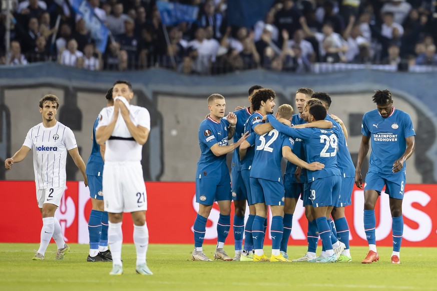 Eindhoven's players celebrate after the 4-0 goal by Cody Gakpo, as Zurich's Lindrit Kamberi, left, and Blerim Dzemaili, 2nd left, react during the UEFA European League Group A soccer match between Swi ...
