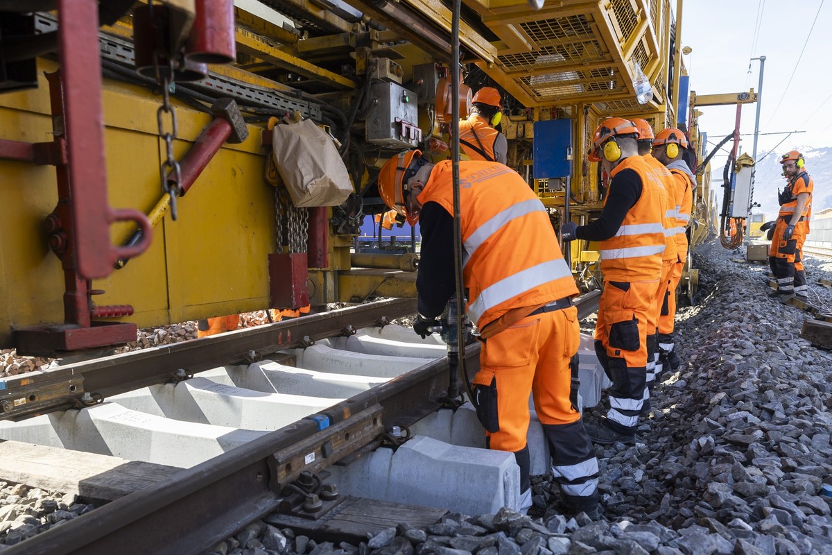 Des ouvriers travaillent sur un chantier ferroviaire des CFF lors d'une visite de chantier ce vendredi, 5 avril 2024 a la gare de Saxon, Valais. (KEYSTONE/Cyril Zingaro)