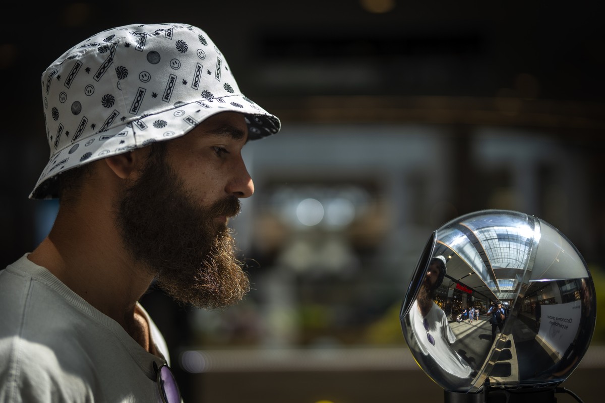 FILE - Daniel Kertusha, 21, has his eyes scanned by an orb at a Worldcoin registration point in Barcelona, Spain, Friday, Aug. 4, 2023. Spain?s privacy watchdog has ordered for Worldcoin to cease its  ...