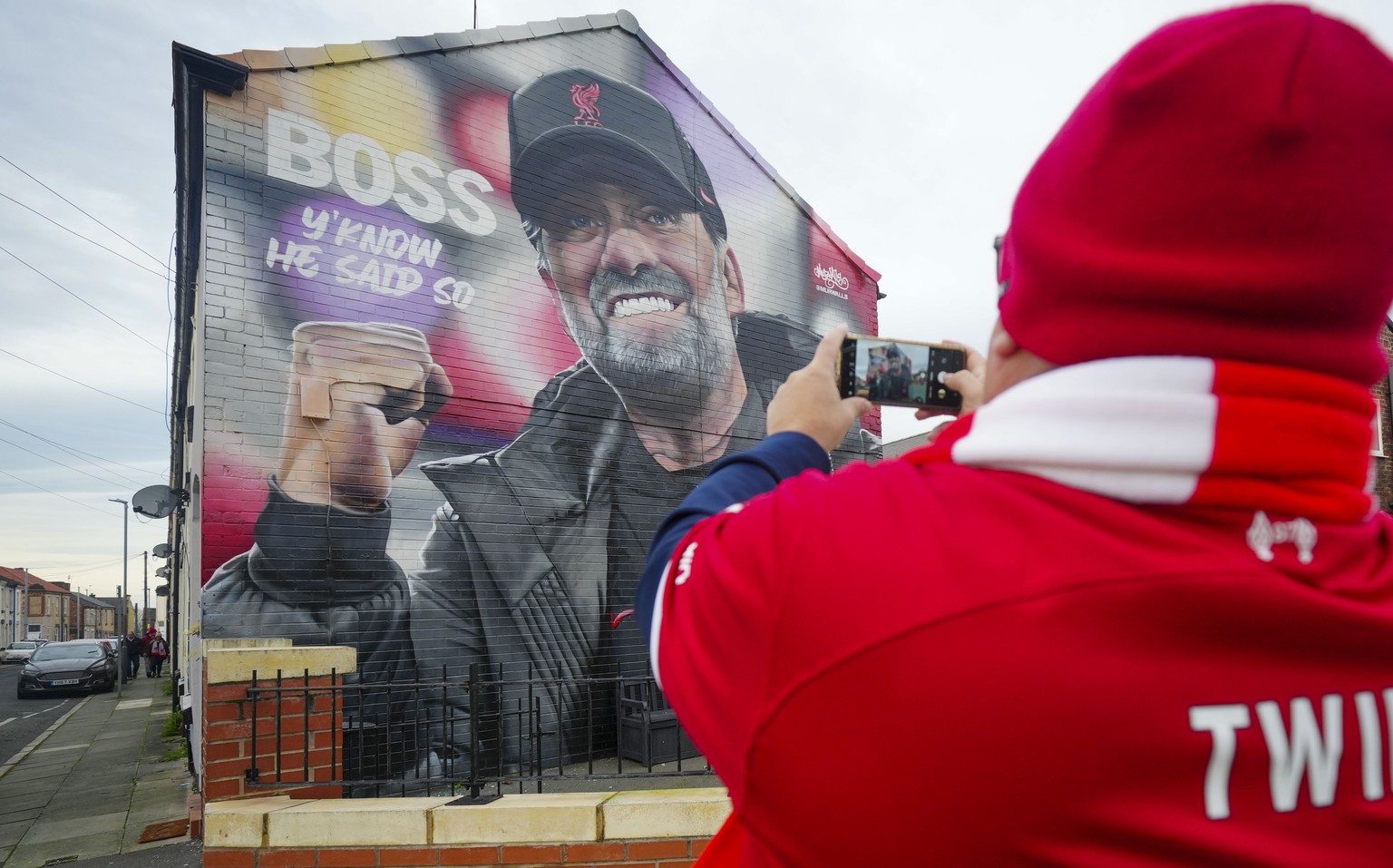 A fan takes a picture of a mural showing Liverpool manager Jurgen Klopp on a house near Anfield stadium prior the English FA Cup fourth round soccer match between Liverpool and Norwich, in Liverpool,  ...