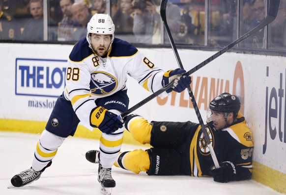 Buffalo Sabres&#039; Cory Conacher (88) skates away after checking Boston Bruins&#039; Johnny Boychuk (55) into the boards during the first period of an NHL hockey game in Boston, Saturday, April 12,  ...