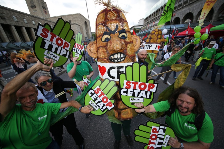 epaselect epa05543951 Activists show placards and effigies during a protest against two international trade agreements, in Stuttgart, Germany, 17 September 2016. Protest marches and demontrations agai ...