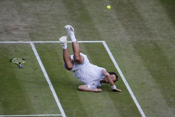 Richard Gasquet of France falls during his match against Stan Wawrinka of Switzerland at the Wimbledon Tennis Championships in London, July 8, 2015. REUTERS/Stefan Wermuth TPX IMAGES OF THE DAY